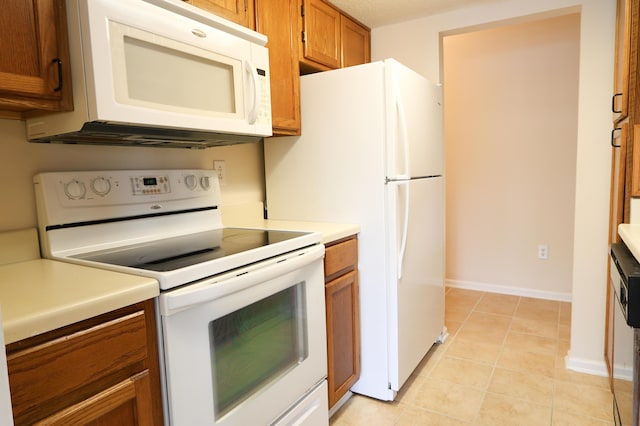 403 Sunny Side Way, Summerville, SC 29485 - kitchen with white appliances, brown cabinetry, light countertops, light tile patterned floors, and baseboards
