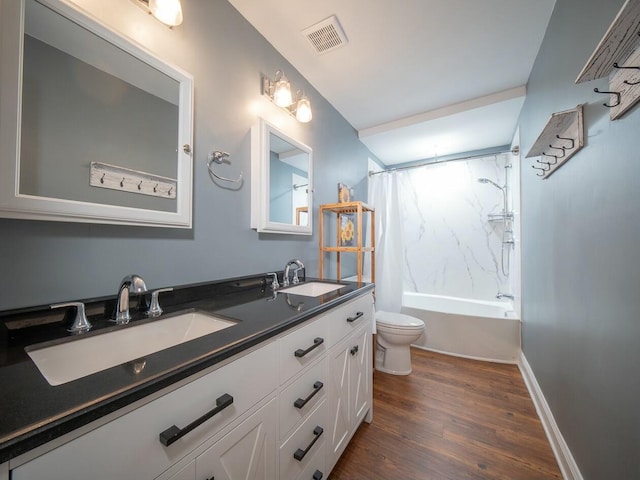 full bathroom featuring a sink, visible vents, toilet, and wood finished floors