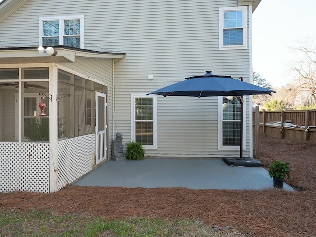 back of house with fence, a patio, and a sunroom