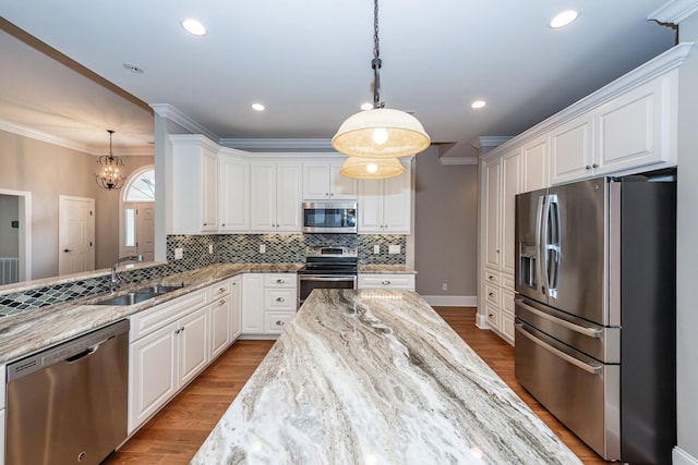 287 Commonwealth Rd, Mount Pleasant, SC 29466 - kitchen featuring a sink, light stone counters, stainless steel appliances, and white cabinetry