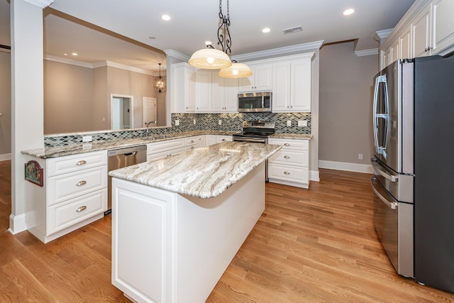 287 Commonwealth Rd, Mount Pleasant, SC 29466 - kitchen featuring visible vents, a kitchen island, white cabinetry, tasteful backsplash, and stainless steel appliances