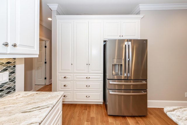287 Commonwealth Rd, Mount Pleasant, SC 29466 - kitchen featuring stainless steel refrigerator with ice dispenser, ornamental molding, white cabinets, and light wood-type flooring
