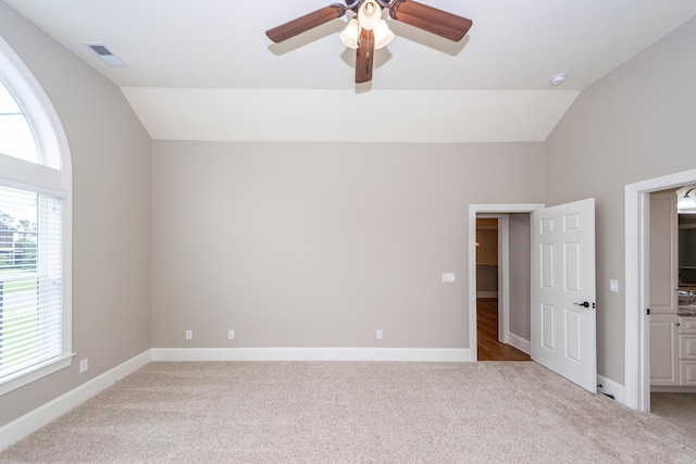 287 Commonwealth Rd, Mount Pleasant, SC 29466 - unfurnished bedroom with light colored carpet, visible vents, multiple windows, and lofted ceiling