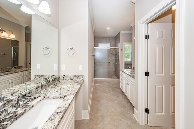 287 Commonwealth Rd, Mount Pleasant, SC 29466 - bathroom with crown molding, a stall shower, two vanities, a sink, and baseboards