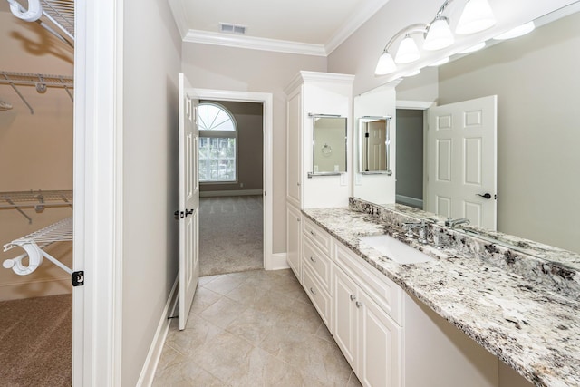 287 Commonwealth Rd, Mount Pleasant, SC 29466 - bathroom featuring crown molding, a walk in closet, vanity, baseboards, and visible vents