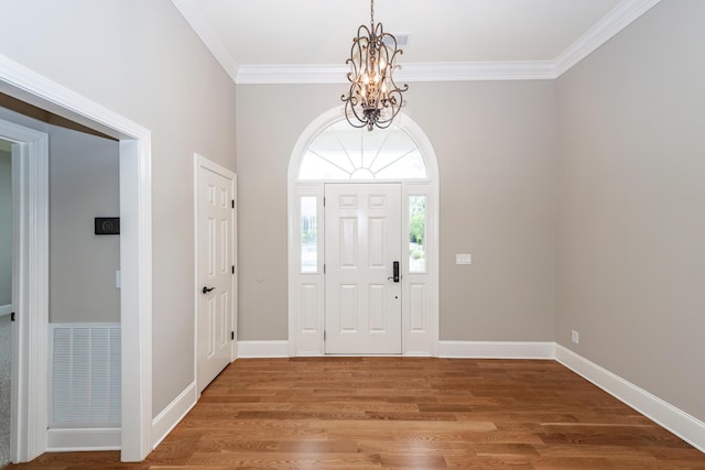 287 Commonwealth Rd, Mount Pleasant, SC 29466 - entrance foyer featuring a notable chandelier, baseboards, wood finished floors, visible vents, and ornamental molding