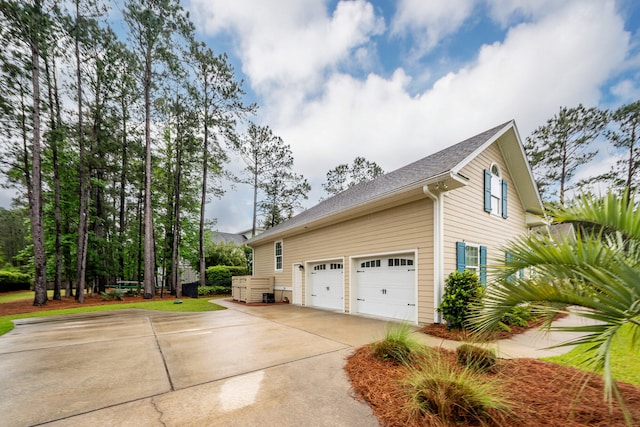 287 Commonwealth Rd, Mount Pleasant, SC 29466 - view of side of home featuring concrete driveway, an attached garage, and a shingled roof