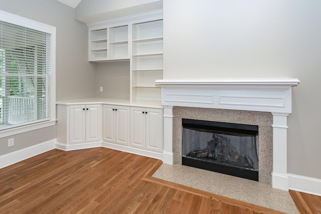 287 Commonwealth Rd, Mount Pleasant, SC 29466 - unfurnished living room with a fireplace with flush hearth, baseboards, and wood finished floors