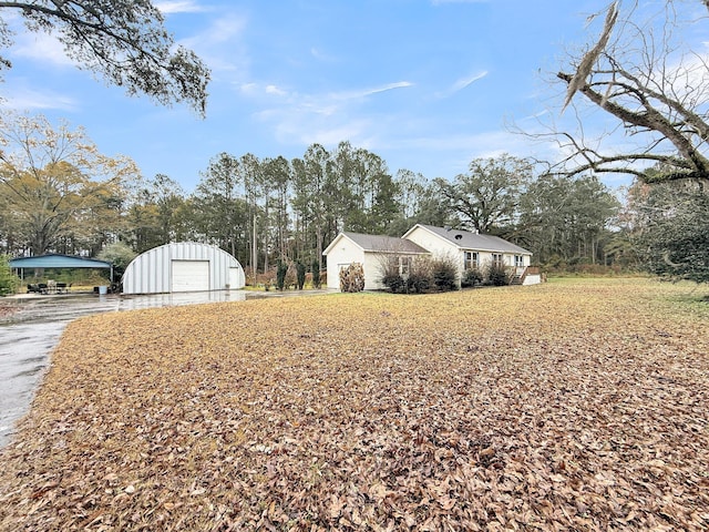 view of side of home with a garage and an outdoor structure