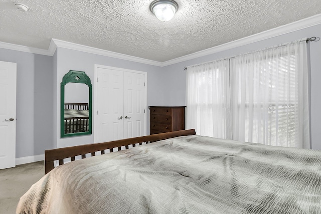 carpeted bedroom featuring a closet, a textured ceiling, and multiple windows