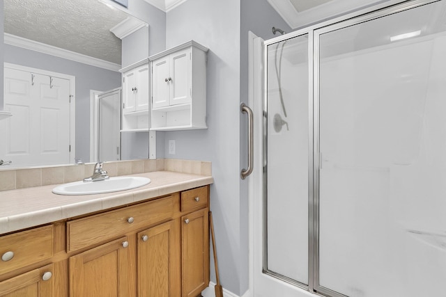 bathroom with walk in shower, a textured ceiling, and ornamental molding