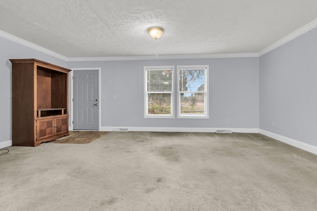 carpeted spare room featuring crown molding and a textured ceiling