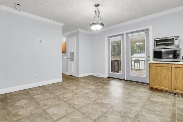 unfurnished dining area featuring a textured ceiling and ornamental molding