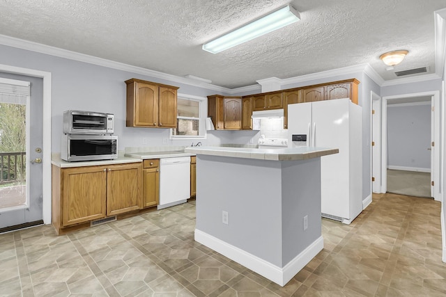 kitchen with a textured ceiling, white appliances, a kitchen island, and ornamental molding