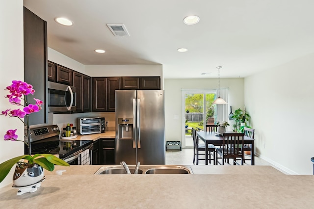 161 Brittondale Rd, Summerville, SC 29485 - kitchen featuring a toaster, light countertops, dark brown cabinets, visible vents, and appliances with stainless steel finishes