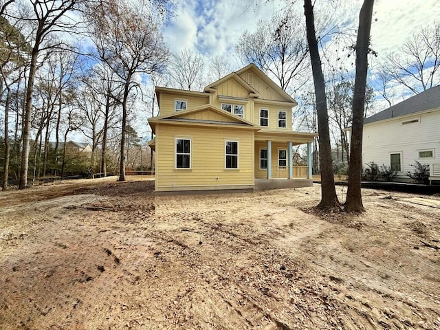 rear view of house featuring covered porch