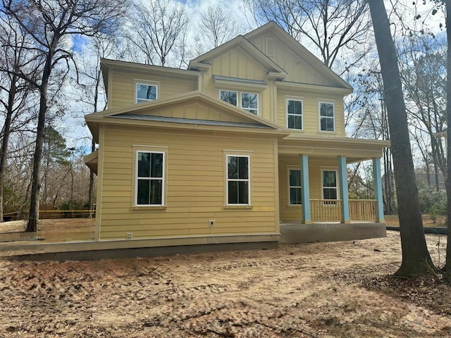 rear view of property featuring a porch