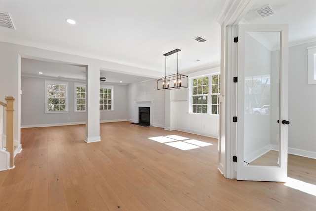 unfurnished living room with plenty of natural light and light hardwood / wood-style flooring