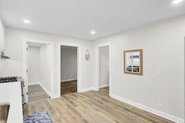 1515 Mulberry St, Charleston, SC 29407 - kitchen with stainless steel range with gas cooktop, recessed lighting, light wood-style floors, baseboards, and range hood