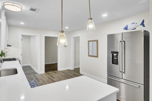 1515 Mulberry St, Charleston, SC 29407 - kitchen with high quality fridge, light countertops, wood finished floors, baseboards, and recessed lighting