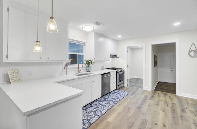 1515 Mulberry St, Charleston, SC 29407 - kitchen featuring appliances with stainless steel finishes, a sink, white cabinets, light countertops, and light wood finished floors