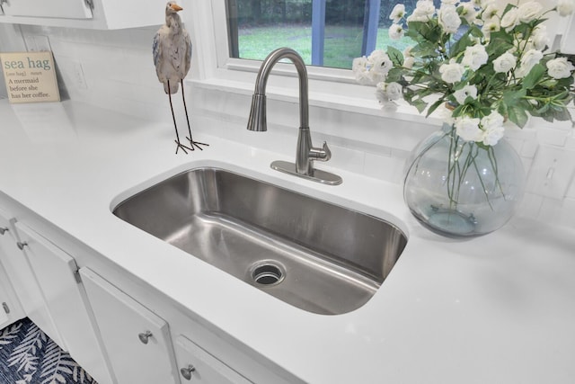 1515 Mulberry St, Charleston, SC 29407 - kitchen view of a sink, backsplash, light countertops, and white cabinetry