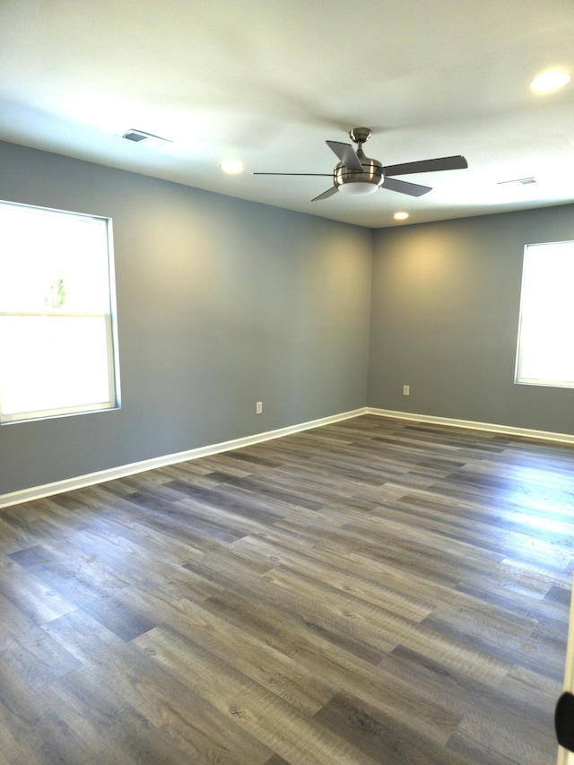 unfurnished room featuring dark hardwood / wood-style floors and ceiling fan