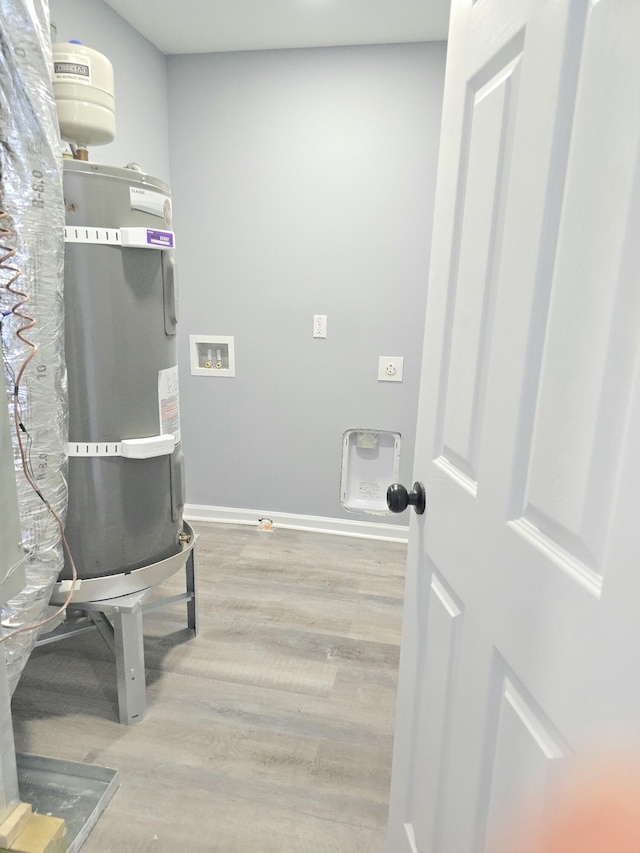 laundry area featuring washer hookup, electric dryer hookup, wood finished floors, laundry area, and baseboards