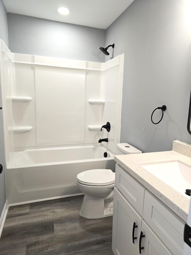 full bathroom featuring shower / bath combination, toilet, wood finished floors, vanity, and recessed lighting