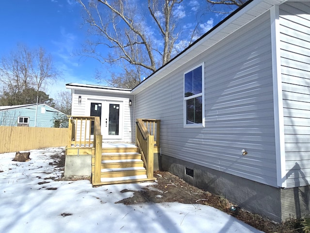 view of snow covered property entrance