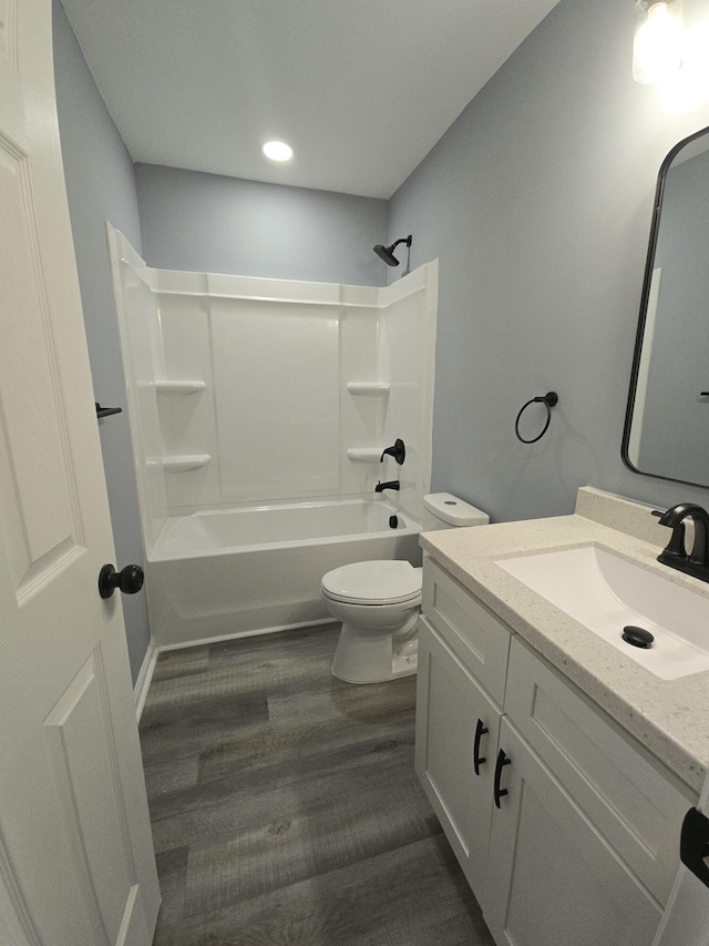 full bathroom featuring washtub / shower combination, vanity, toilet, and wood finished floors