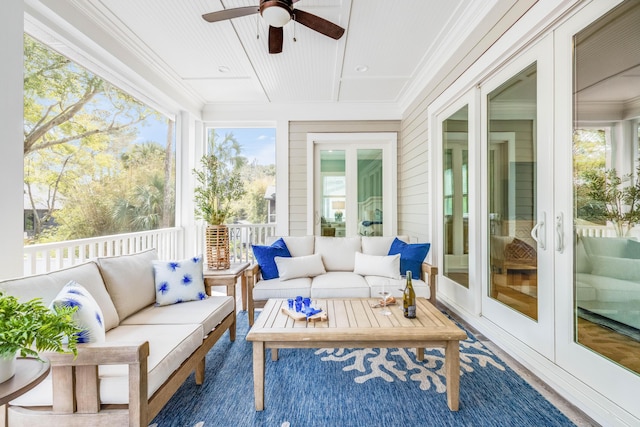 sunroom featuring a ceiling fan