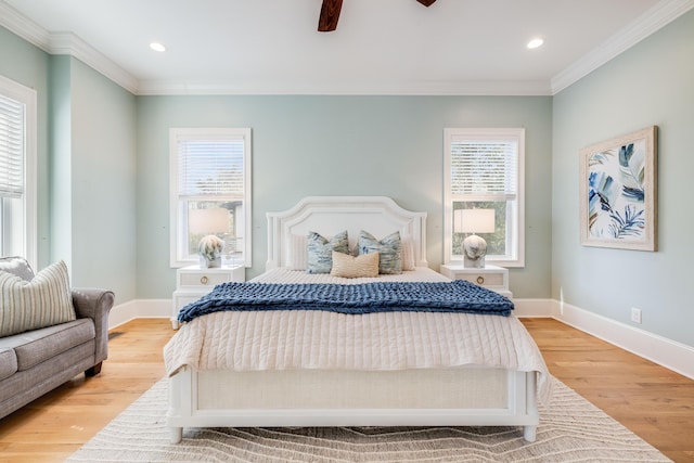 bedroom with light wood finished floors, baseboards, and ornamental molding