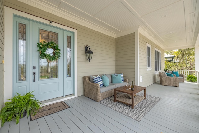 wooden deck with outdoor lounge area and covered porch