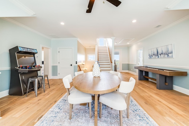 dining room featuring ceiling fan, wood finished floors, and ornamental molding