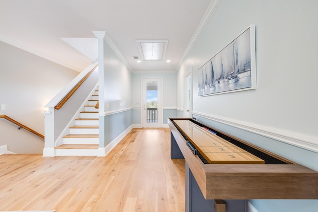 recreation room featuring baseboards, attic access, wood finished floors, and crown molding