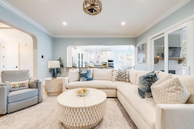 living room featuring arched walkways, recessed lighting, and crown molding