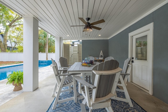 view of patio with outdoor dining space, fence private yard, a fenced in pool, and ceiling fan