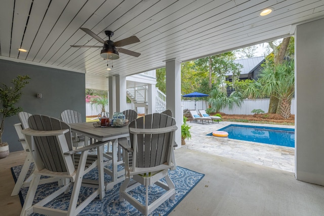 view of patio / terrace featuring outdoor dining space, stairway, a fenced in pool, a fenced backyard, and ceiling fan