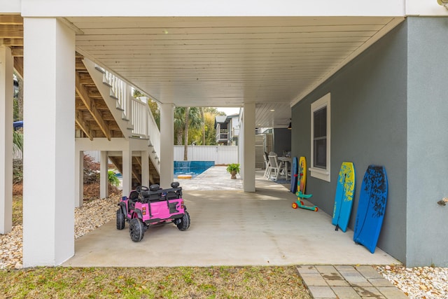 view of patio / terrace with stairway and fence