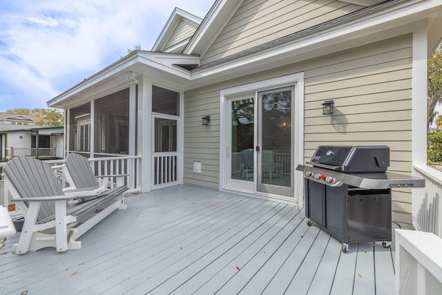 wooden terrace featuring area for grilling and a sunroom