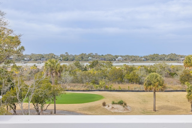 view of home's community featuring a lawn and a water view