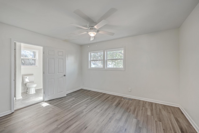 unfurnished bedroom featuring ceiling fan, light wood-type flooring, visible vents, and baseboards