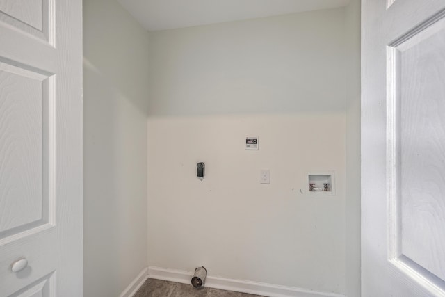 clothes washing area with hookup for a washing machine, laundry area, and baseboards