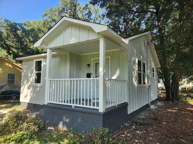 view of front of house featuring crawl space, covered porch, and board and batten siding