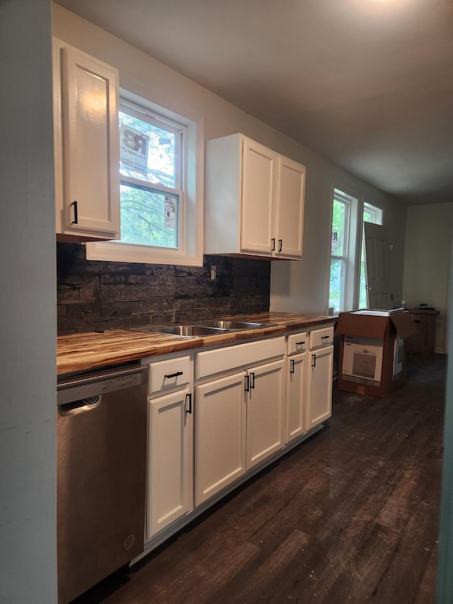 kitchen with tasteful backsplash, white cabinets, dishwasher, dark wood-type flooring, and wooden counters