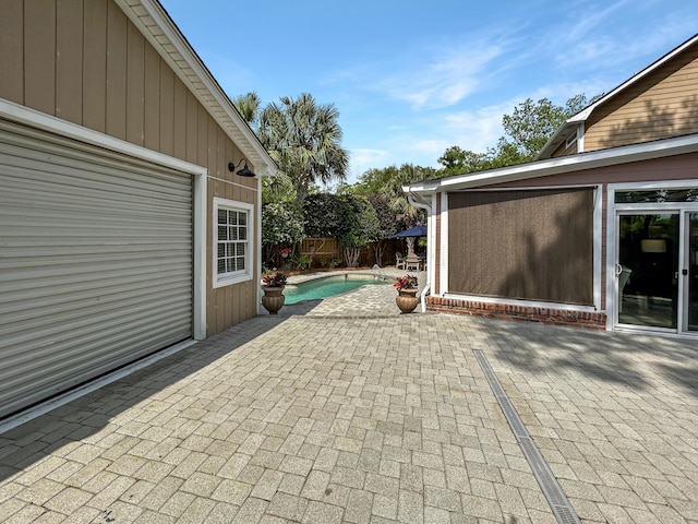view of patio featuring fence and a fenced in pool