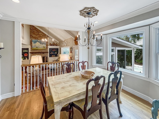dining space featuring lofted ceiling with beams, a notable chandelier, baseboards, and a healthy amount of sunlight