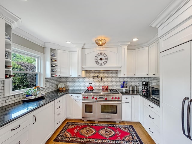 kitchen featuring double oven range, light wood finished floors, open shelves, and white cabinetry
