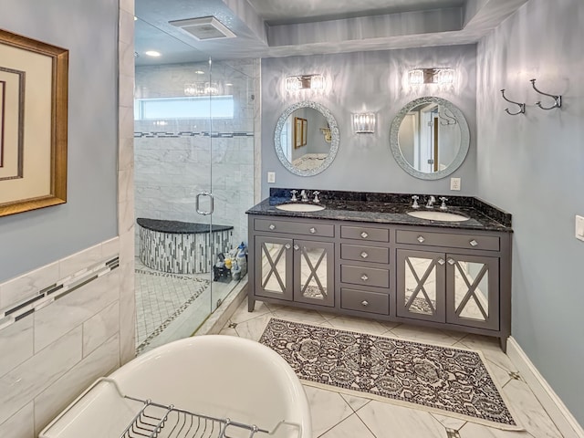 full bath with a freestanding tub, visible vents, a shower stall, and a sink